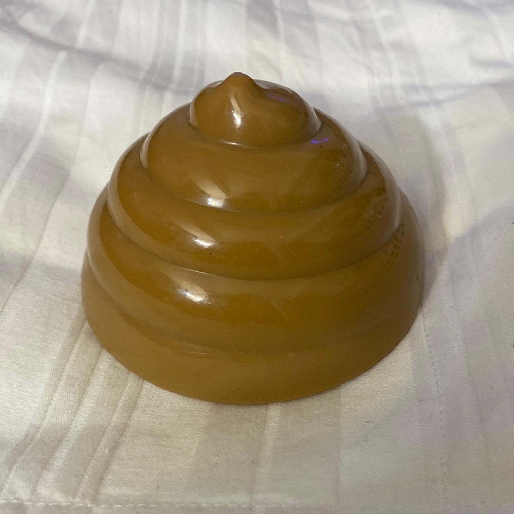 SOLD!!!top to a toy, but it resembles a pile of what? It looks like a poop pile